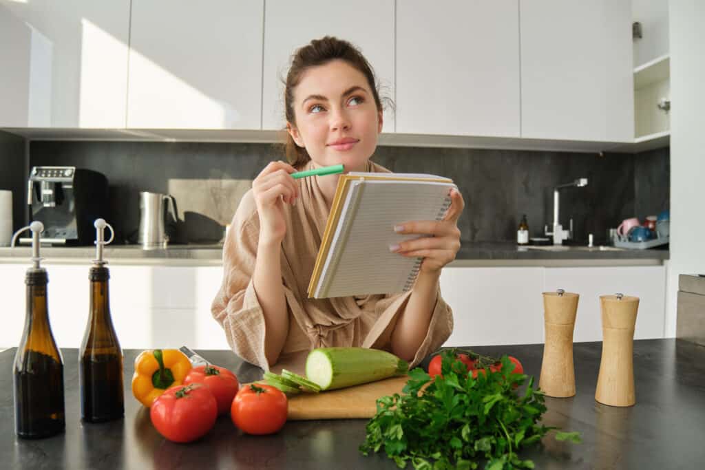 vecteezy portrait of woman checking recipe notes in notebook 35340088